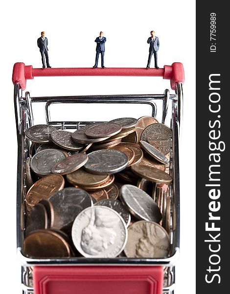 Businessman figurines standing on a shopping cart filled with coins. Businessman figurines standing on a shopping cart filled with coins