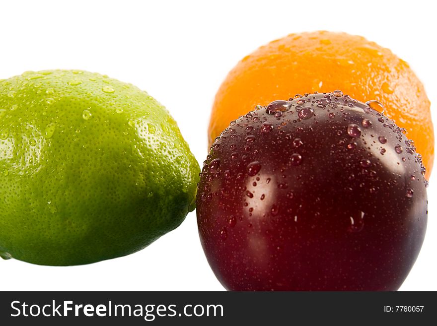 Orange, lemon, apple and plum on white background