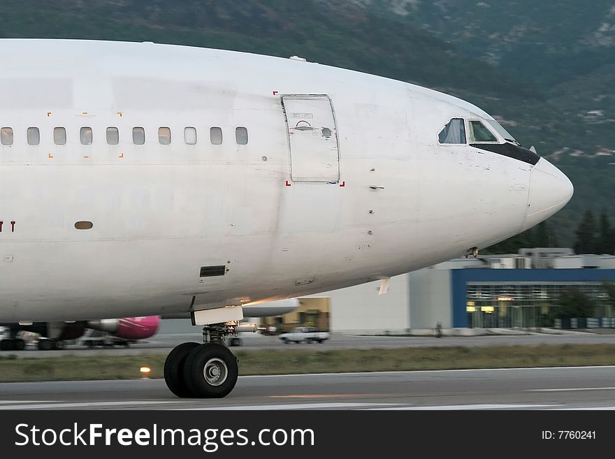 Wide-body passenger airplane is taxiing prior to departure. Wide-body passenger airplane is taxiing prior to departure