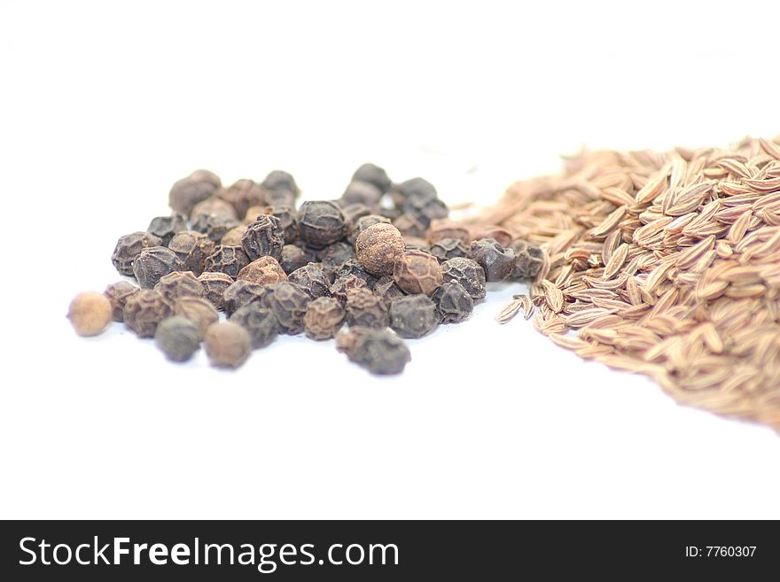 Black pepper caraway seed on white background