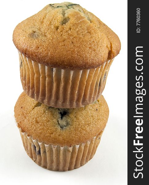 Two blueberry muffins stacked and isolated on white. Two blueberry muffins stacked and isolated on white.