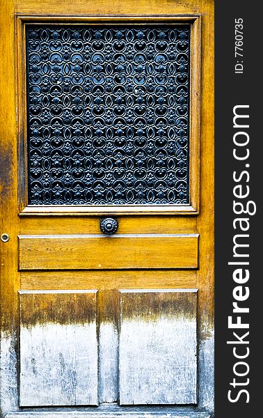 Weathered antique door with center knob, Paris, France