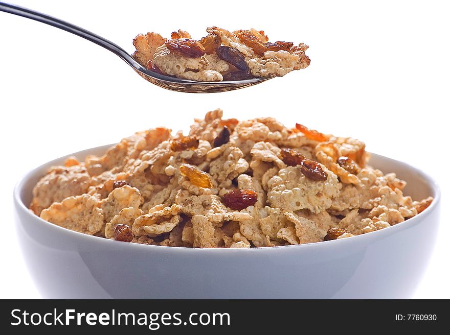 Bowl of cereal with raisins and milk isolated