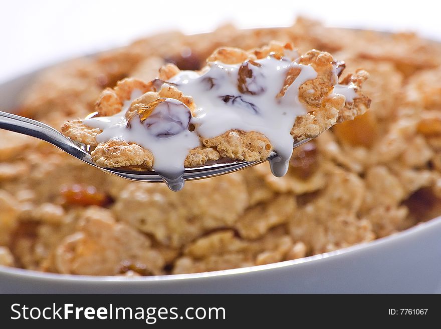 Bowl of cereal with raisins and milk isolated