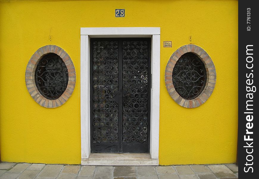 Yellow doorway round windows