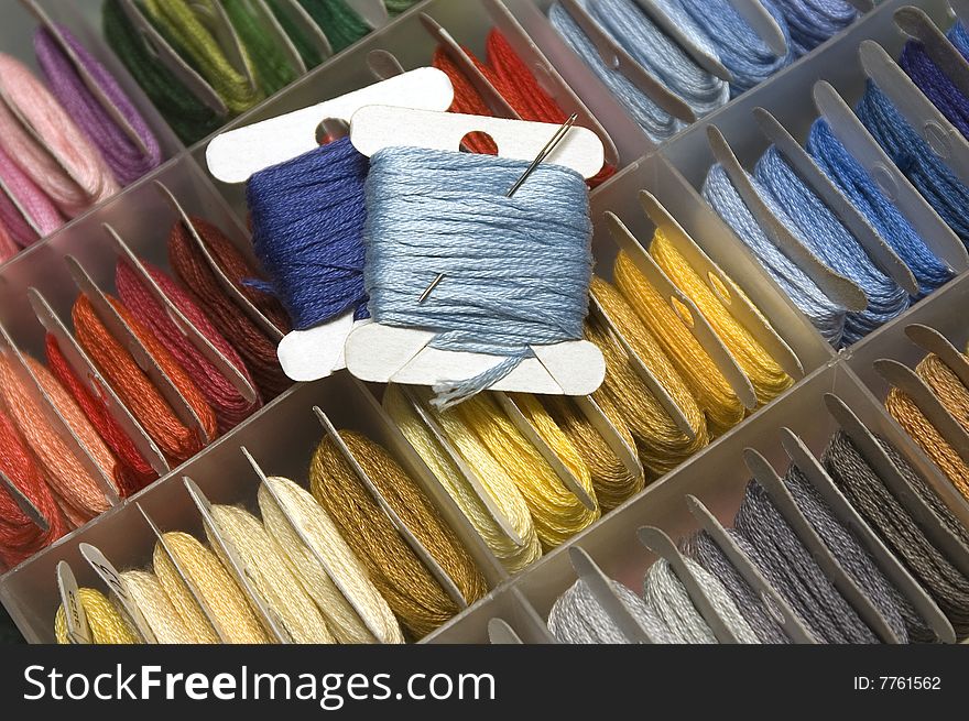 Plastic box with multi-coloured mouline threads. Plastic box with multi-coloured mouline threads