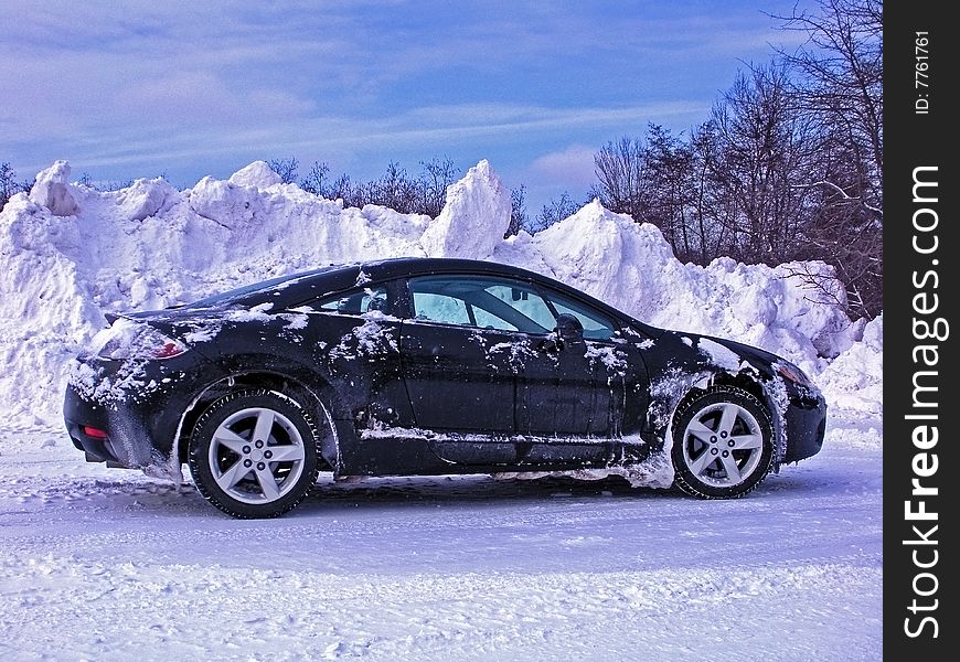 New car parked in winter snow. New car parked in winter snow.