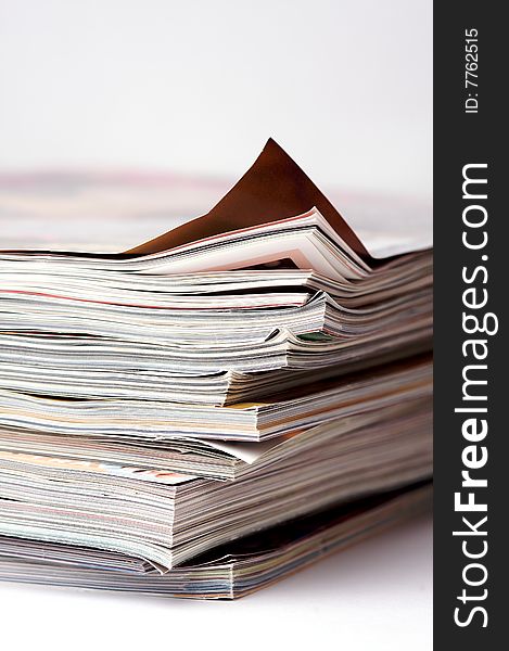 A stack of magazines on an isolated white background