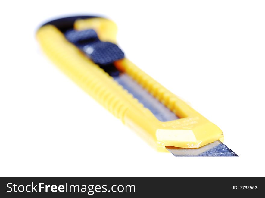 Sharp retractable utility knife with yellow plastic handle. Isolated on the white background. Narrow depth of field. Sharp retractable utility knife with yellow plastic handle. Isolated on the white background. Narrow depth of field.