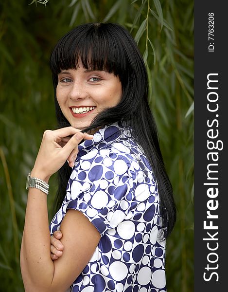 Playful lovely woman smiling in summer park. Playful lovely woman smiling in summer park