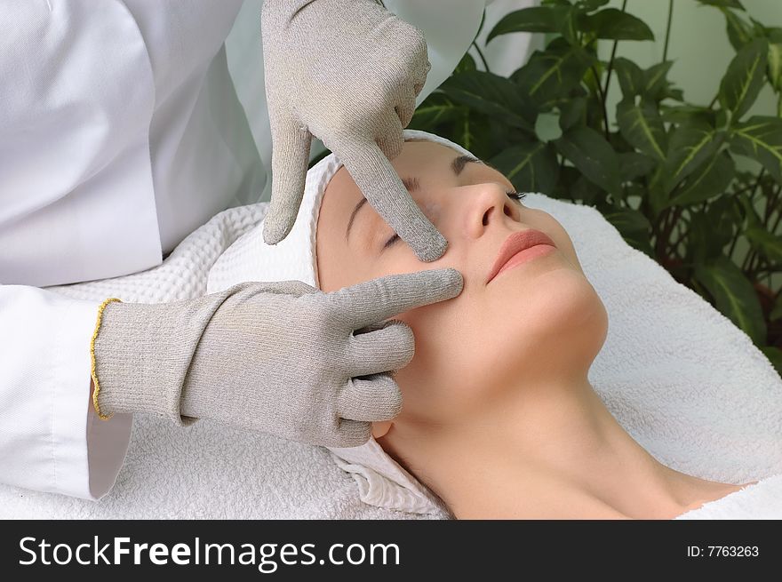 Woman getting special facial massage in the beauty salon. Woman getting special facial massage in the beauty salon