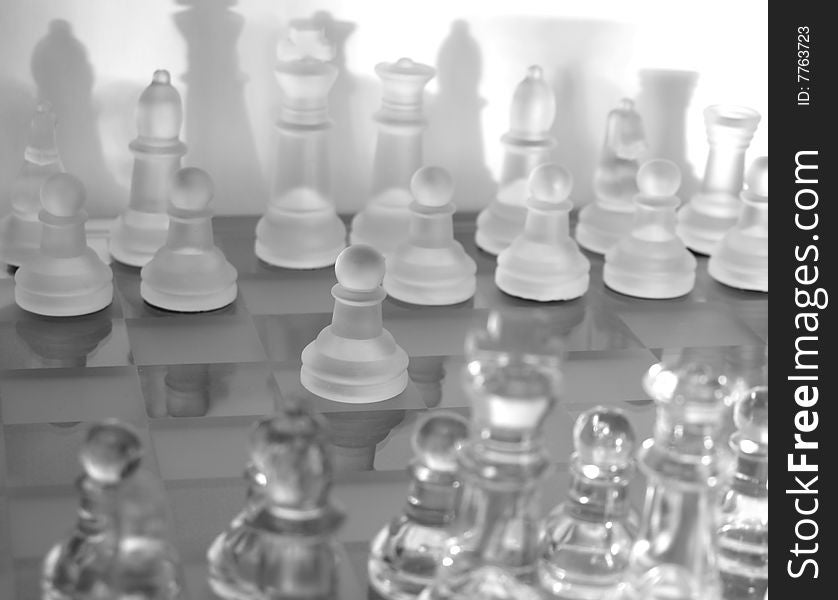 Glass chess on the glass chessboard