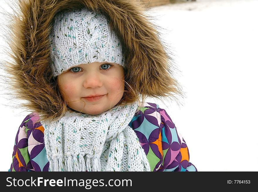 Winter portrait of smiling small girl, background white