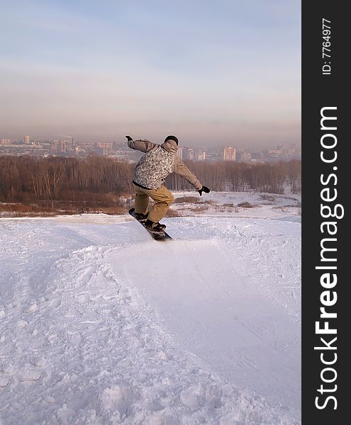 Snowboarder Flying Over The Snowy City