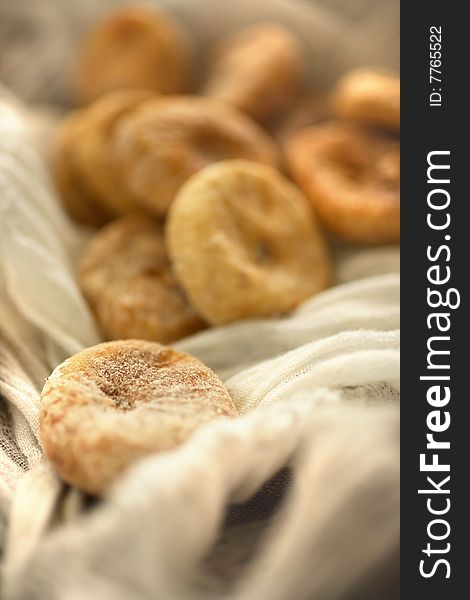 Dry figs in linen tablecloth on table