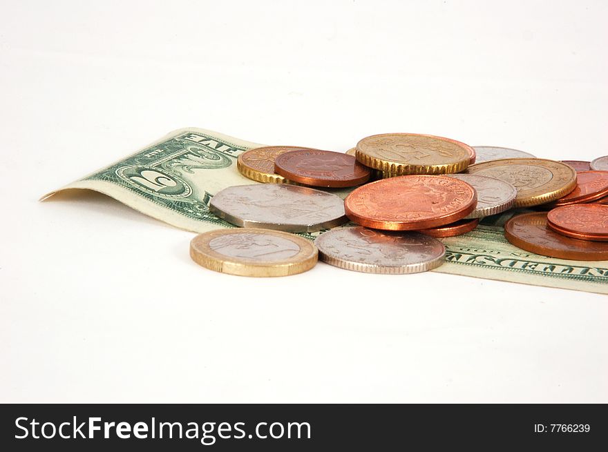 Five dollar paper money with worldwide coins isolated on the white background. Five dollar paper money with worldwide coins isolated on the white background.