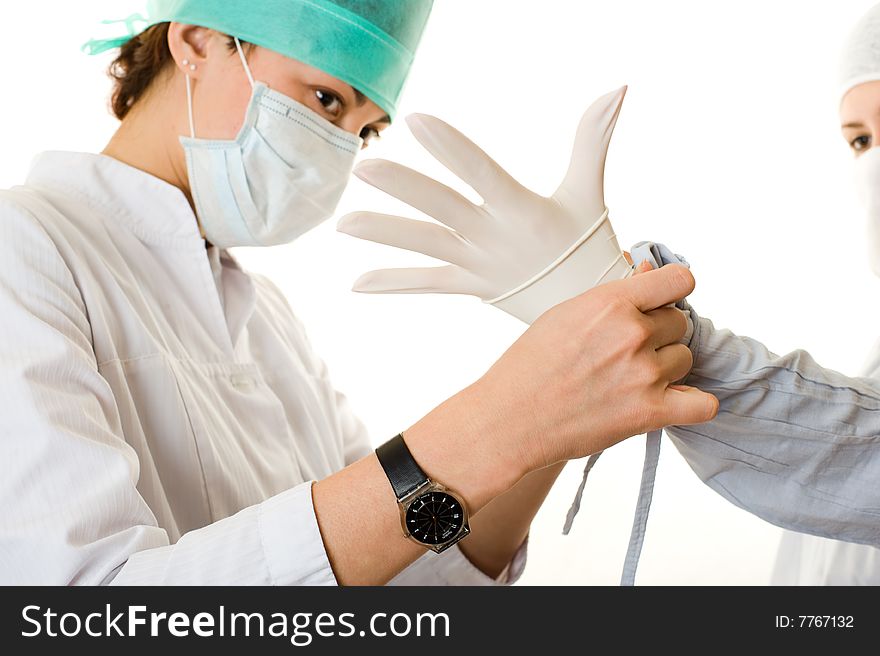 Two young doctors put on a glove Isolated on white background