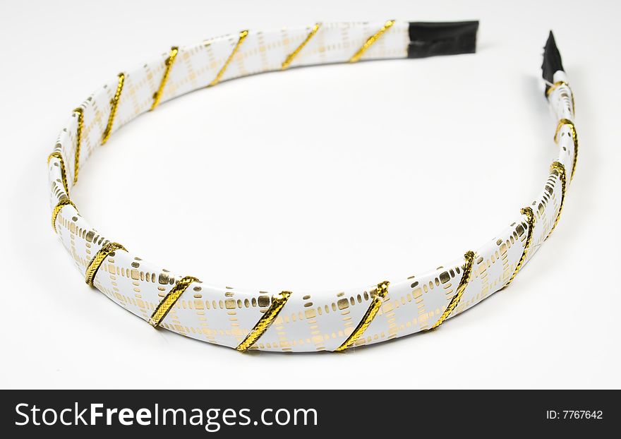 Rim for hair with golden ornament on a white background