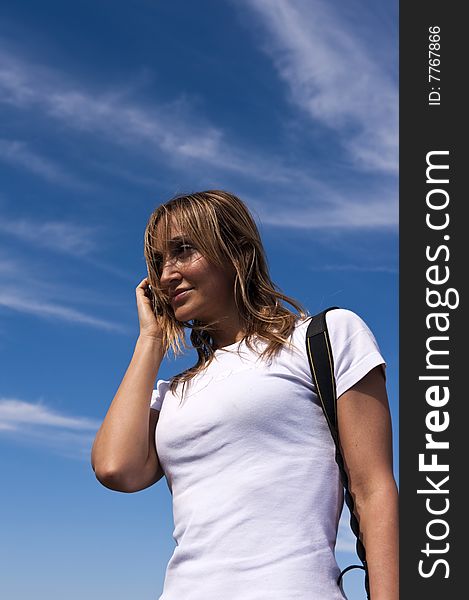 Young woman talking on a cellphone on a sunny day