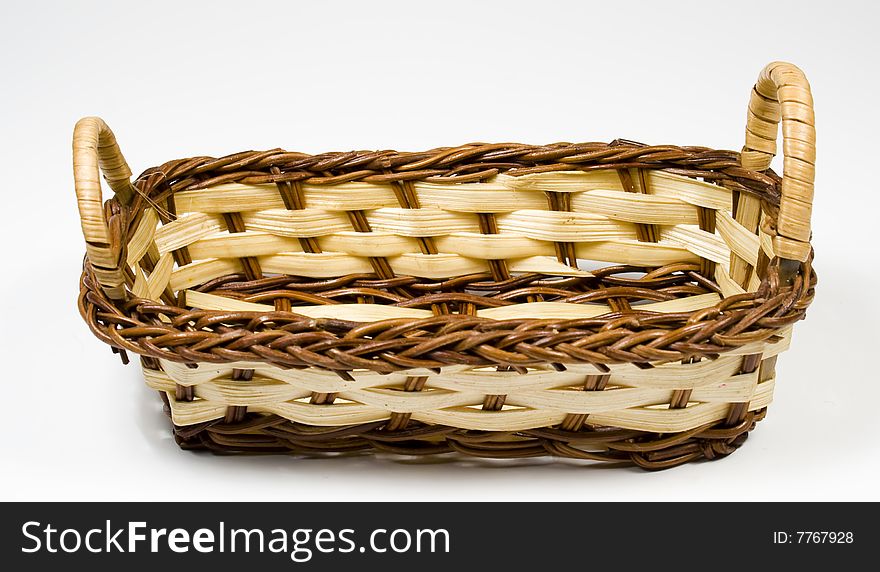 Bast basket from wooden strips of yellow and brown colour