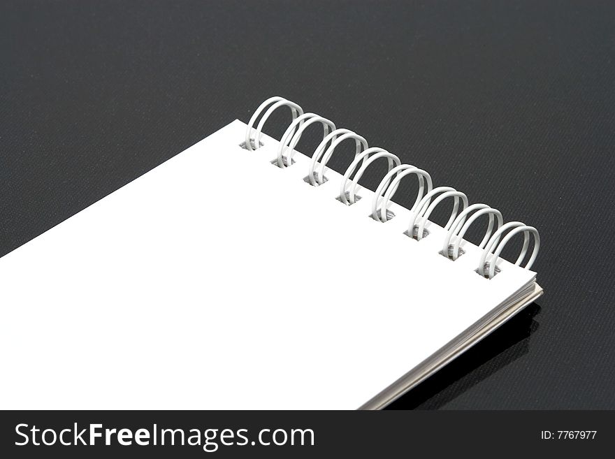 White notebook black background isolated.