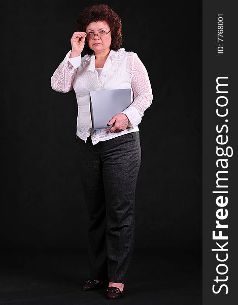 Business woman on black background in studio