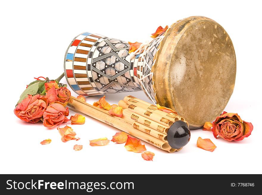 Asian musical instrument decorated with dried red roses and rose petals isolated on white background. Asian musical instrument decorated with dried red roses and rose petals isolated on white background