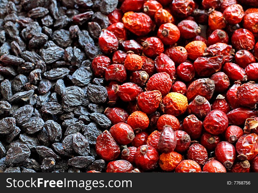 Close up of the black raisins and red hips. Close up of the black raisins and red hips