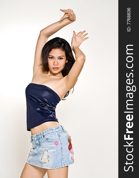 Stylish asian young woman in dancing pose. Stylish asian young woman in dancing pose