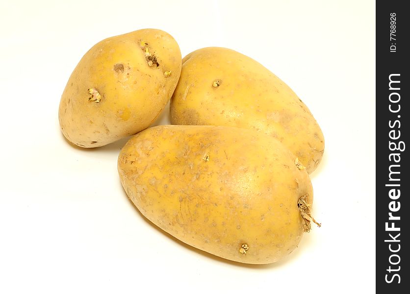 Three potatoes isolated on white background, closeup