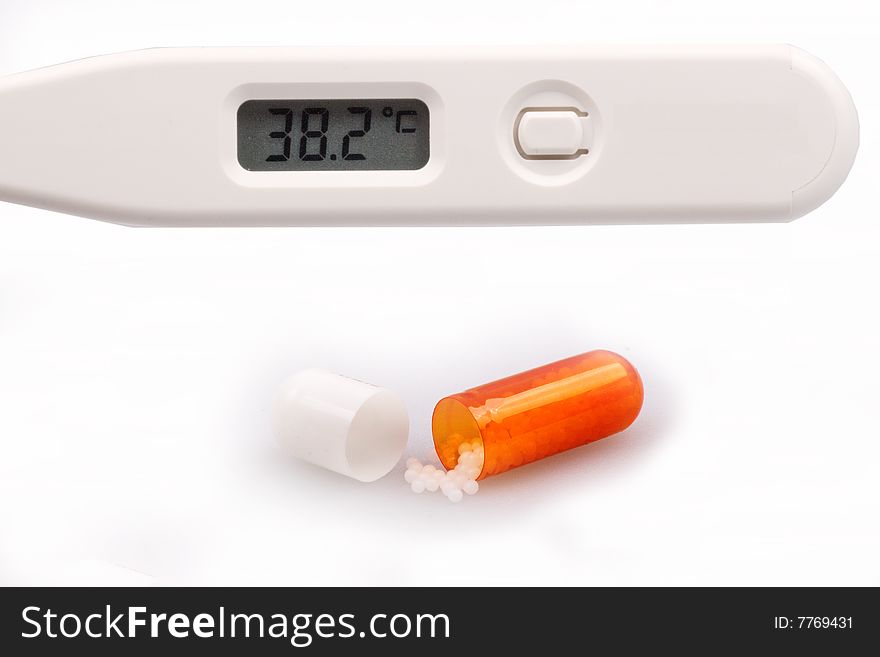 Digital thermometer and capsules medicine on white background.
