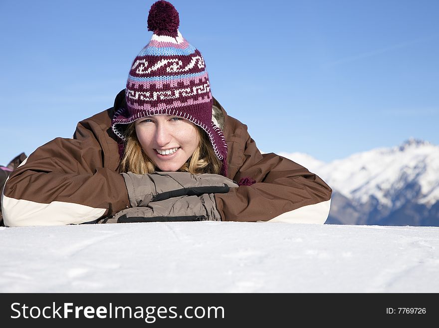 Young woman lying down on snow. Copy space. Young woman lying down on snow. Copy space