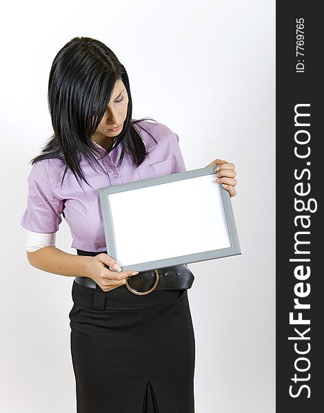 Attractive businesswoman holding a frame. Attractive businesswoman holding a frame