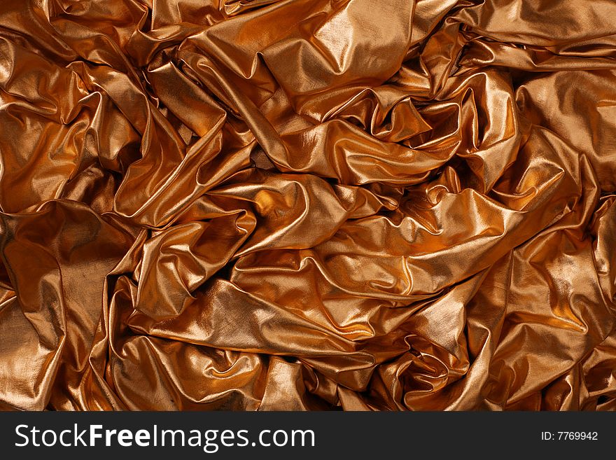 Abstract gold silk background with folds. Abstract gold silk background with folds