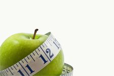 Green Apple Wrapped By A Measuring Tape Stock Photography