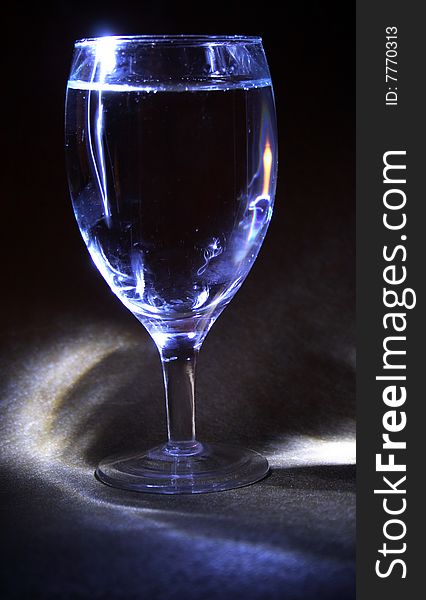 Glass of white wine on darck background