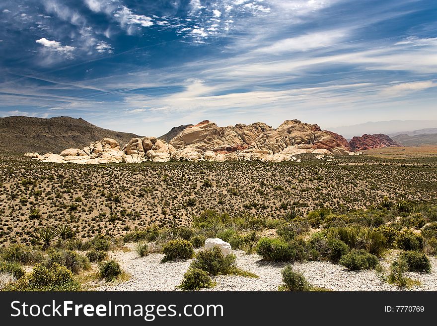 Nice rocks in the Red Rock Canyon National Reserve, Nevada, USA near Las Vegas. Desert bushes in the foreground.