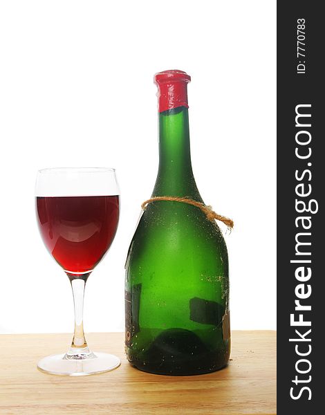 Glass of red wine and a green wine bottle. Glass of red wine and a green wine bottle