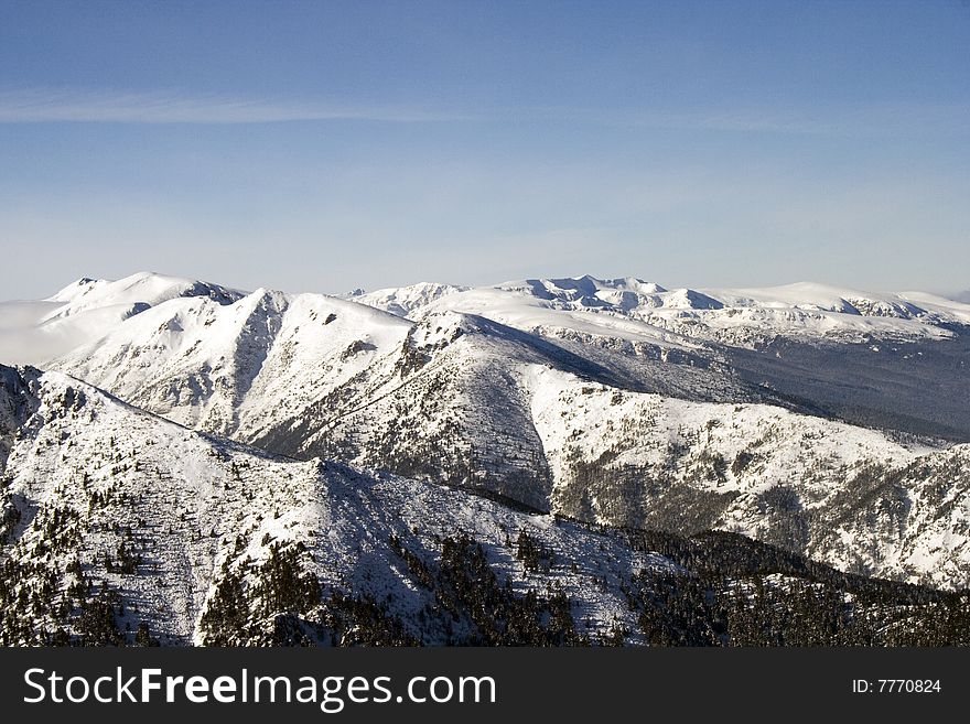 A snow - white mountain range over 3400 m. A snow - white mountain range over 3400 m.
