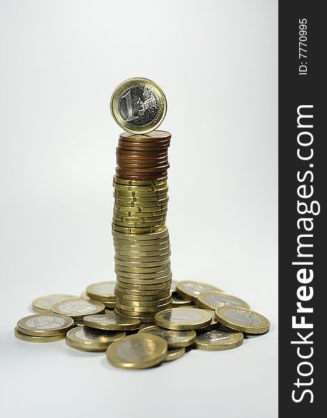 A tower made up of Euro coins, with a single one Euro coin on top. A tower made up of Euro coins, with a single one Euro coin on top