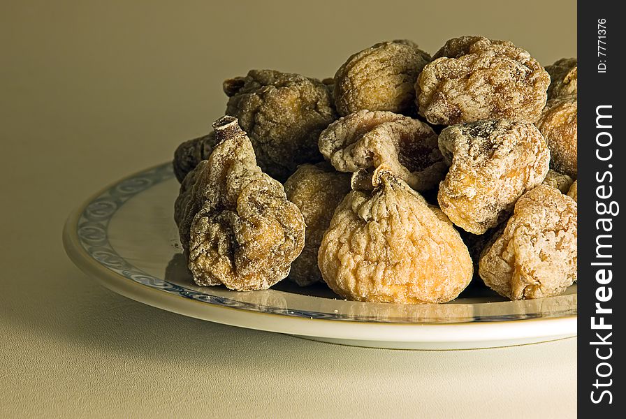 Dried figs on a plate in a retro image style.