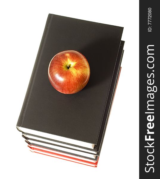 Apple and books isolated on white