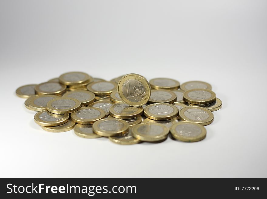 One Euro coins, with a single one standing upright