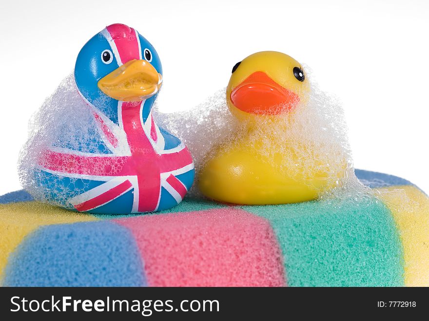 Two rubber duck against a bubbly