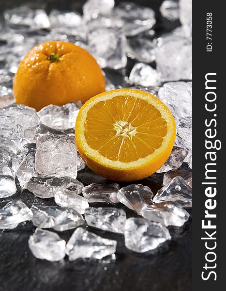 Orange on black slate with ice