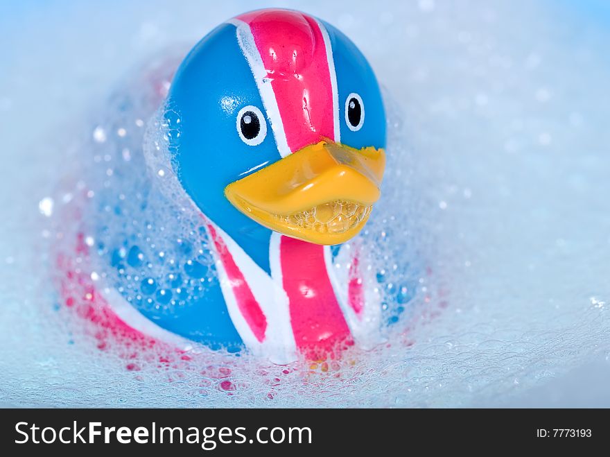 Rubber duck against a bubbly blue background