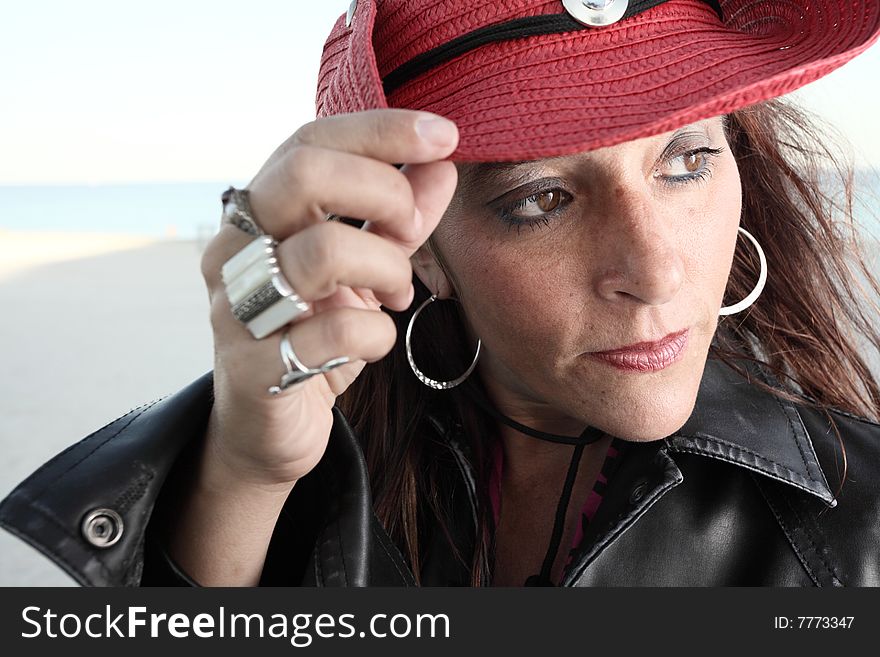 Middle aged female wearing a red cowboy hat. Middle aged female wearing a red cowboy hat