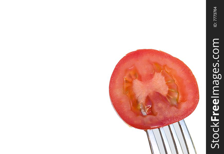 Slice of the red tomato on  a fork
