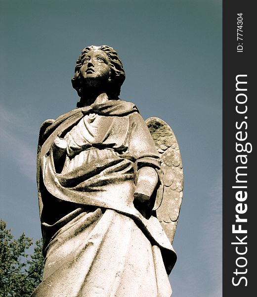 A beautiful, solitary angel of stone stands guard over loved ones forever.  Her missing left hand abruptly interrupts the intensity of the love this beautiful sculptured angel emits. A beautiful, solitary angel of stone stands guard over loved ones forever.  Her missing left hand abruptly interrupts the intensity of the love this beautiful sculptured angel emits.