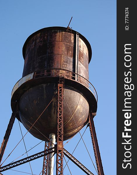 An old rusted water tower still in use. An old rusted water tower still in use